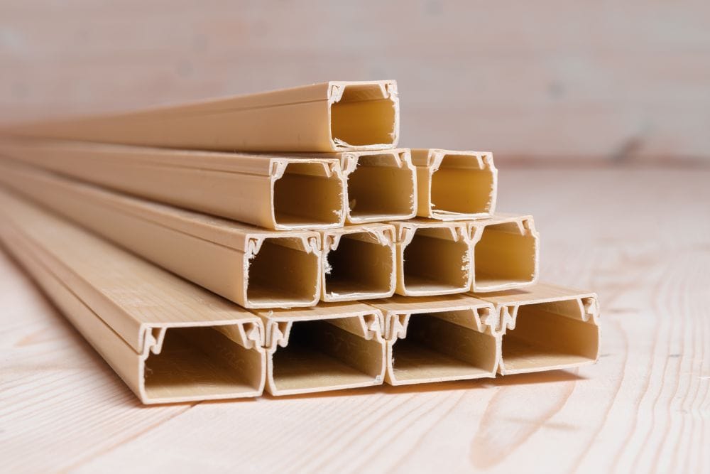 stack of empty beige plastic cable channels